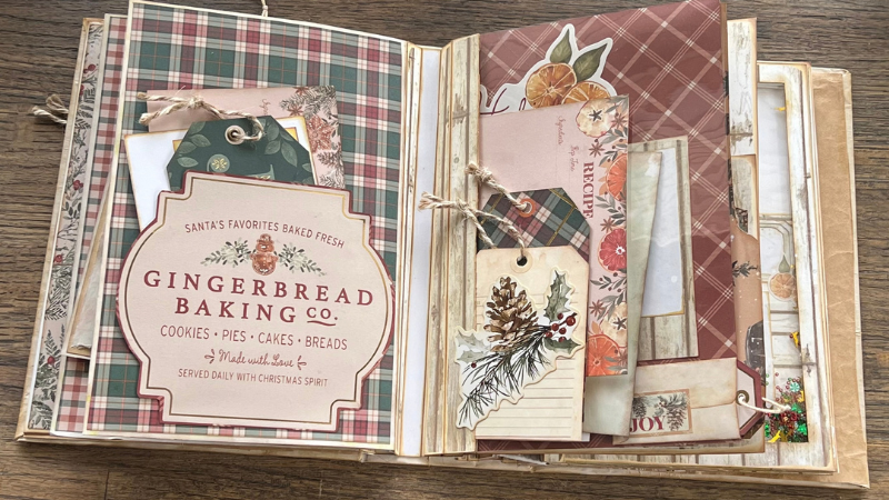 Open handmade journal with decorative paper and ephemera